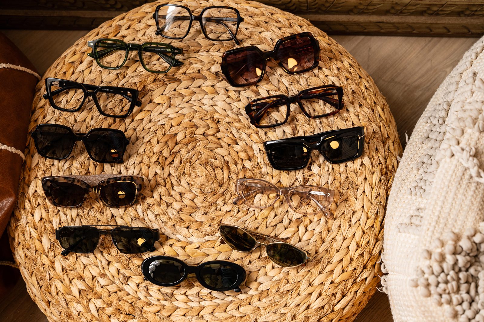 Sunglasses arranged on a rattan surface for Greiche & Scaff